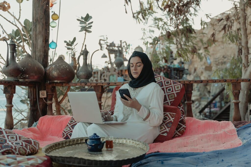 Woman Working on Laptop and Cellphone